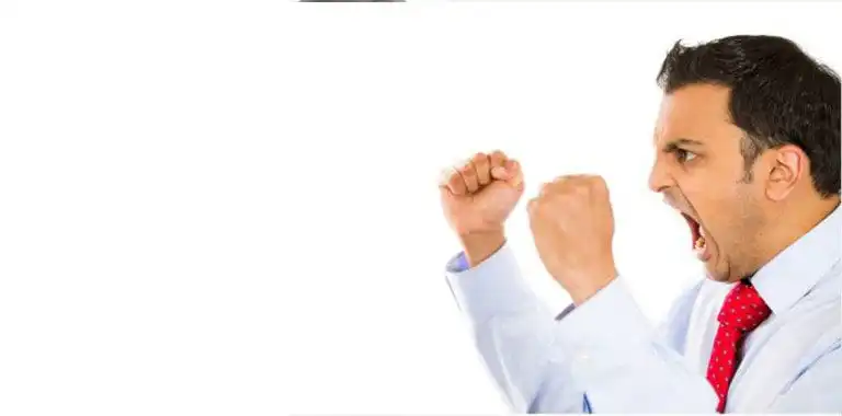 Man shouting with fists raised