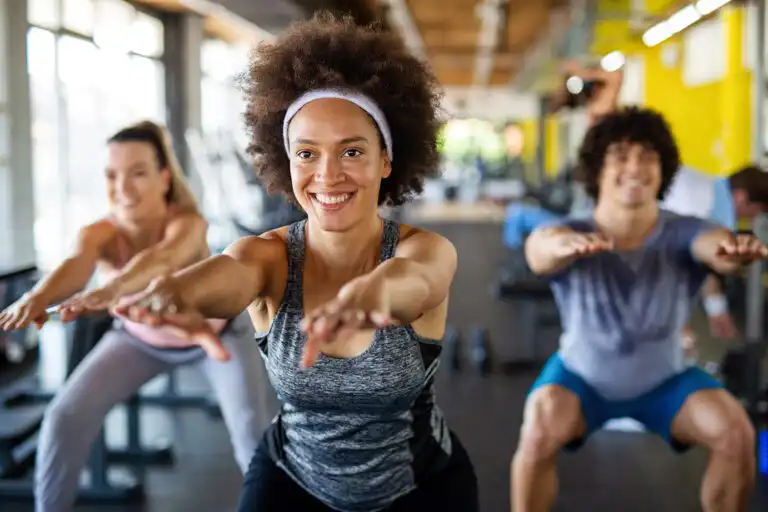 Women squatting in gym