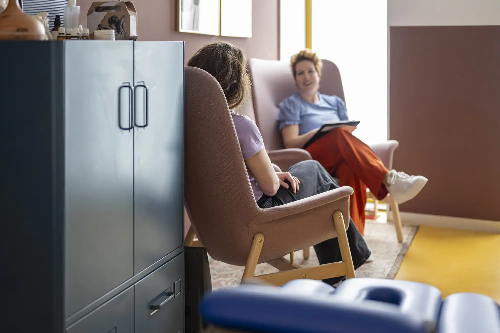 Two people talking indoors