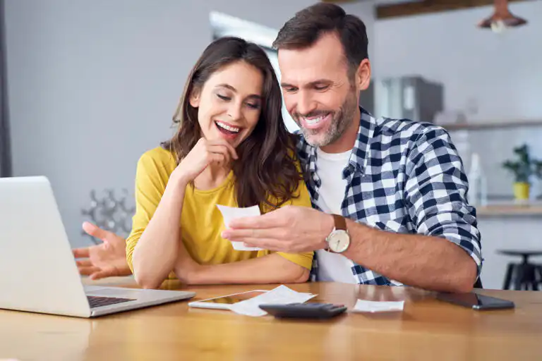 Couple reviewing finances happily
